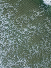Aerial photo of waves breaking near a rural surf beach, New Zealand. 
