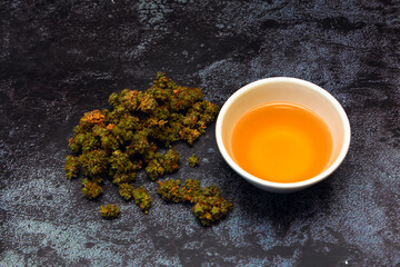 Cannabis buds with bowl of canna tea-4