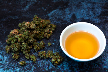 Cannabis buds with bowl of canna tea-1