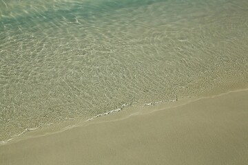 A close up of a beach with water