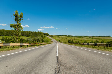 Fototapeta premium Beautiful road through the mountains in summer