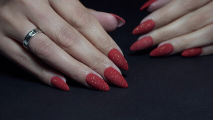 red long nail manicure on dark background