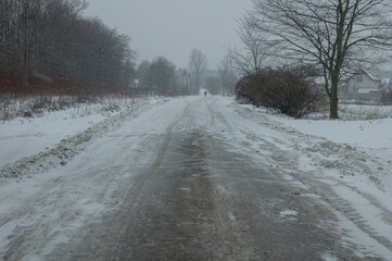 Obraz premium Direct winter road during heavy snow without cars.