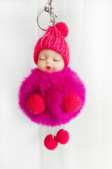Adorable little purple baby doll with hat. White background.