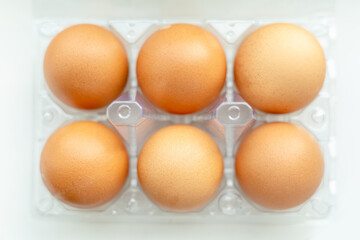 tray with chicken eggs on a light background, top view