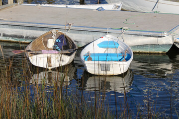 Colorful rowboats are reflected in the water near the St. Johns River in St. Augustine, Florida