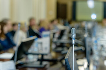 Business people work discussion concept, microphone in the foreground.