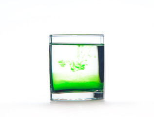 Green ink in water, color abstraction, color explosion in a glass.