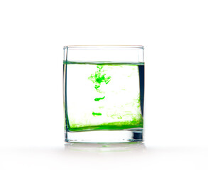 Green ink in water, color abstraction, color explosion in a glass.