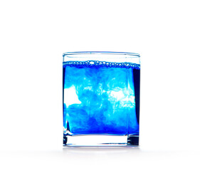 Blue ink in water, color abstraction, color explosion in a glass.