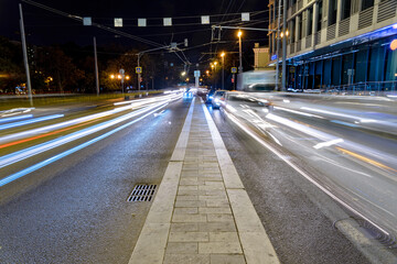 Cityscape with a highway, traffic light and cars, shot at long exposure.