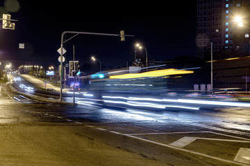 Cityscape with a highway, traffic light and cars, shot at long exposure.