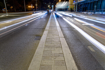 Cityscape with a highway, traffic light and cars, shot at long exposure.