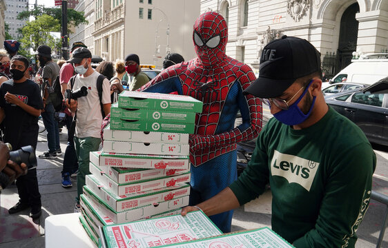 A man dressed as Spider-Man delivers pizza to a protest to defund the police in a place they are calling the "City Hall Autonomous Zone" in support of "Black Lives Matter" in the Manhattan borough of New York City