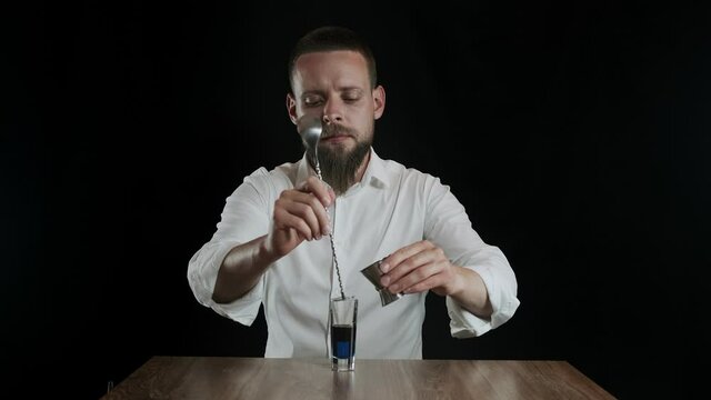 Preparing of Lexus Cocktail. Close up pouring sambuca into a glass