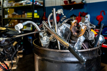 Scrap metal for junk removal in a mechanic automobile repair shop. Car parts for recycling metal.