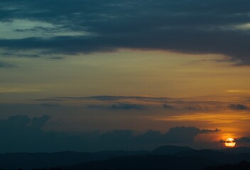 warm summer sunset with sun and clouds in the caribbean