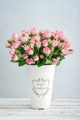 Bouquet of pink roses in a white vase