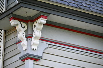 Corner of a house with elaborate scroll work. 
