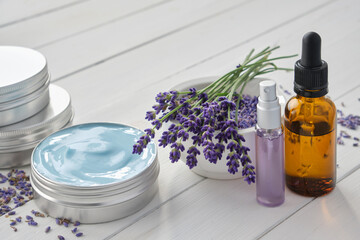 Natural lavender cream, bunch of lavender flowers, dropper bottle of essential lavender oil and...