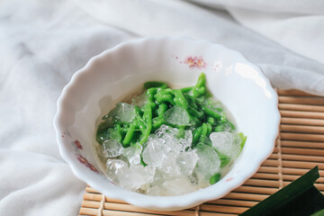 Lod chong or Cendol dessert sweetmeat is a Thai pandan short vermicelli in palm sugar syrup and coconut milk.