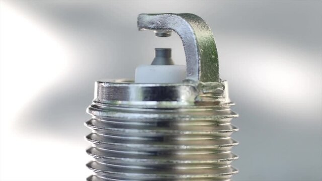 Macro view of a new spark plug. Rotation