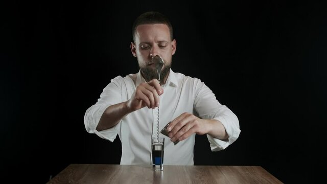 Preparing of Lexus Cocktail. Bartender pouring irish cream into glass