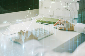 Double exposure of abstract creative financial chart with hand typing on computer keyboard on background, research and strategy concept