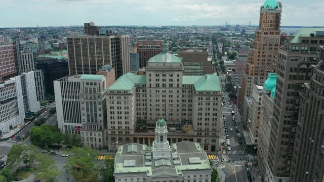 lower aerial flying forward reveal of BLM sign painted on Joralemon St. in downtown Brooklyn