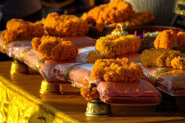 Beautiful marigold flowers along with merit making items
