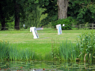 Obraz na płótnie Canvas targets for arrows with stuck arrows on the green lawn by the pond in an english park
