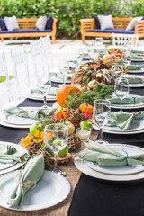 Formal Thanksgiving table and chavari chairs in the fall family group for holiday dinner