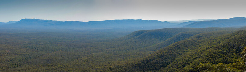 wide panorama showing the densely forested Grampians national park mountain range stretching off into the distance on a clear summer day, regional Victoria, Australia
