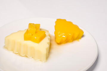 Homemade mango and coconut pudding. Fruit dessert with mango on white background