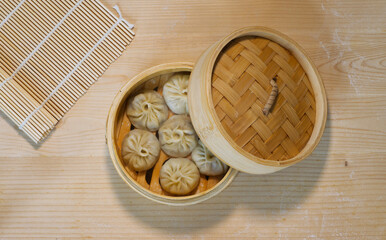 Fototapeta premium Top view of steamed buns in bamboo steamer, homemade Chinese traditional food