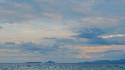 Sky with clouds above the ocean, calm water surface