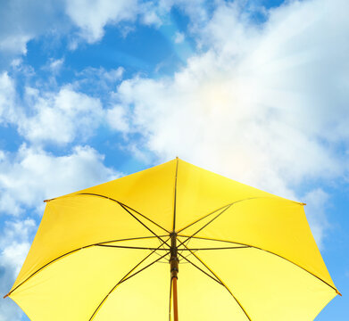 Modern Yellow Umbrella Against Blue Sky. Sun Protection