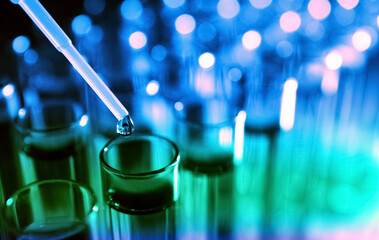 Dripping reagent into test tube with liquid sample, closeup. Laboratory analysis