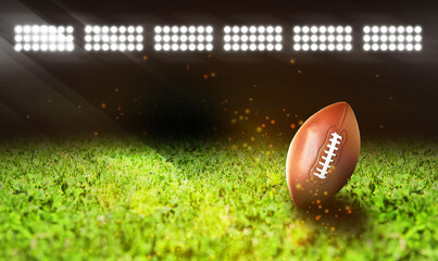 Leather American ball on green football field, space for text