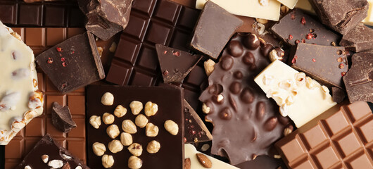 Many different delicious chocolate bars as background, top view. Banner design
