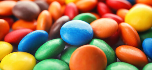 Many colorful candies as background. Banner design
