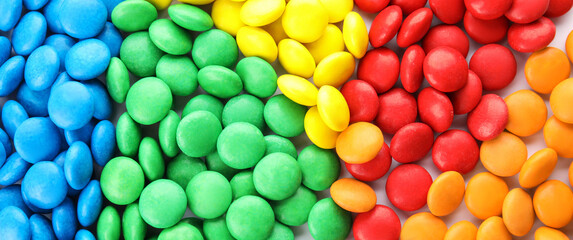 Many colorful candies as background, top view. Banner design