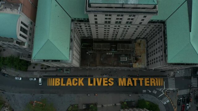 aerial view of BLM sign painted on Joralemon St. in downtown Brooklyn tilting up to horizon