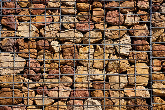 A gabion wall of rocks and steel mesh