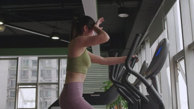 Side view close up of young pretty Asian girl running in the gym healthy lifestyle woman training indoor fitness lifestyles 