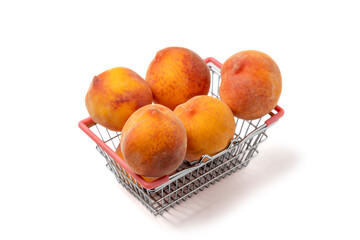 Peaches. Juicy sweet peaches in a mini basket for shopping isolated on a white background.