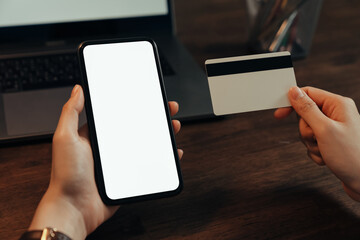 Woman hand using smartphone and holding credit card with payment online on mobile.