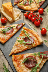 Tasty pepperoni pizza with arugula on wooden table