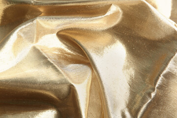 Texture of beautiful golden fabric as background, closeup