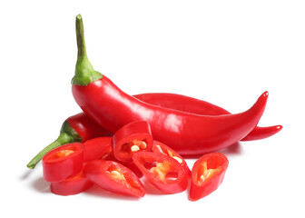 Cut and whole red hot chili peppers on white background